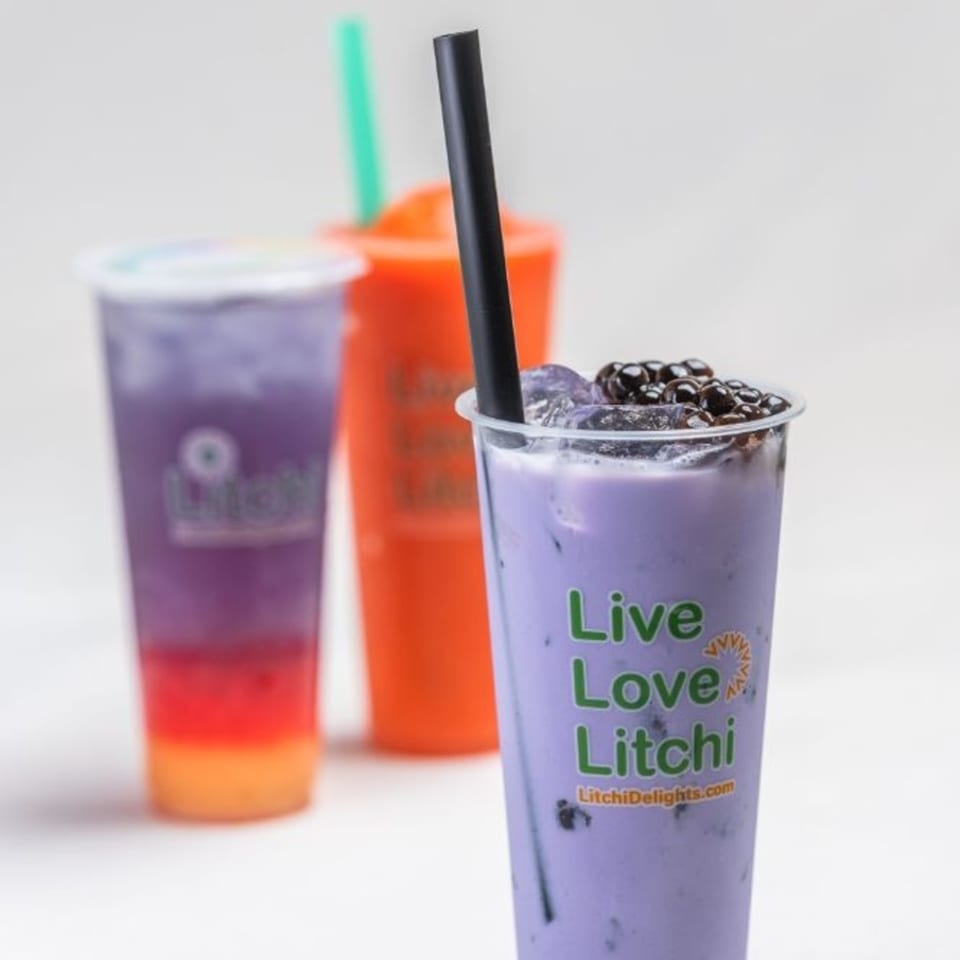 Three Litchi Ramen boba drinks: purple with tapioca, layered purple/red/orange, and orange with a green straw.