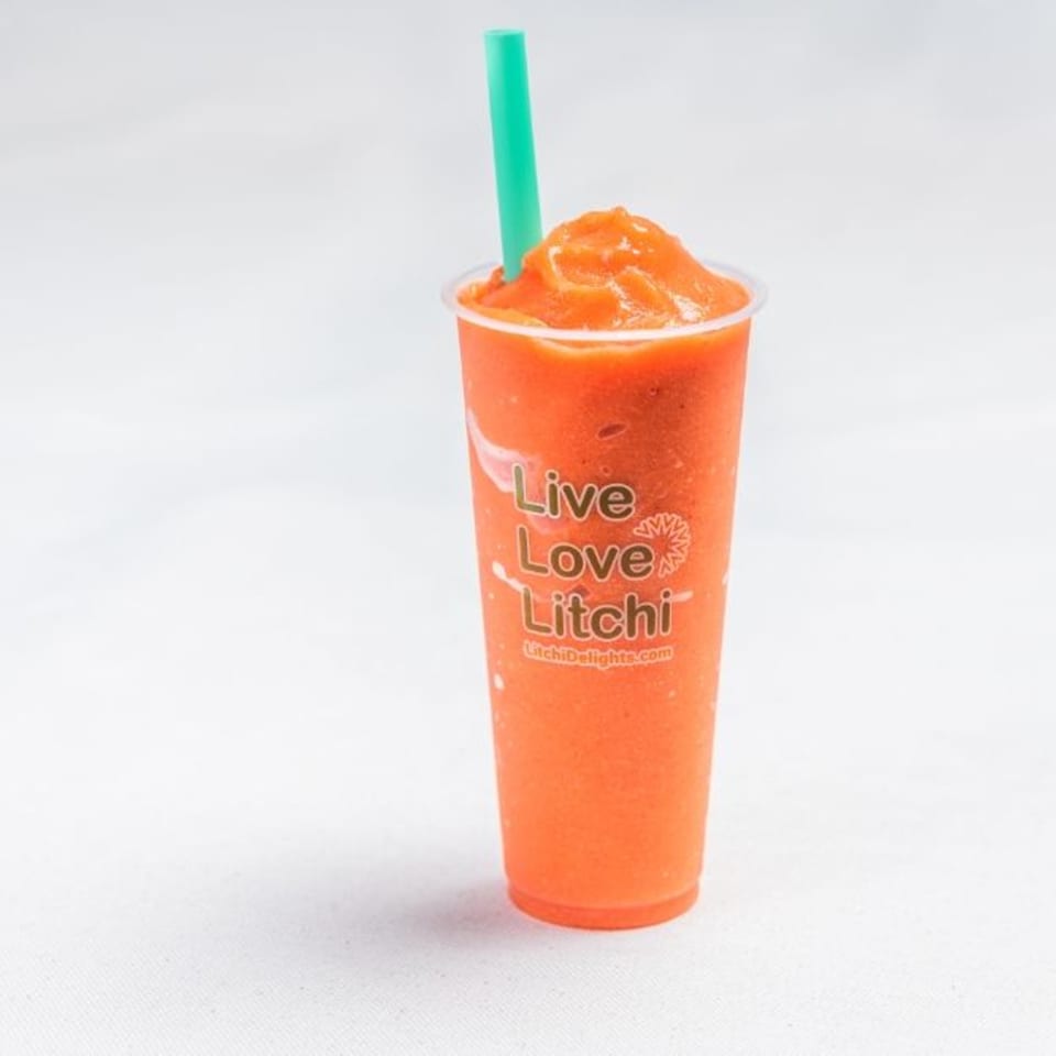 A Litchi Ramen boba drink, an orange slushy with a green straw, on a white background.